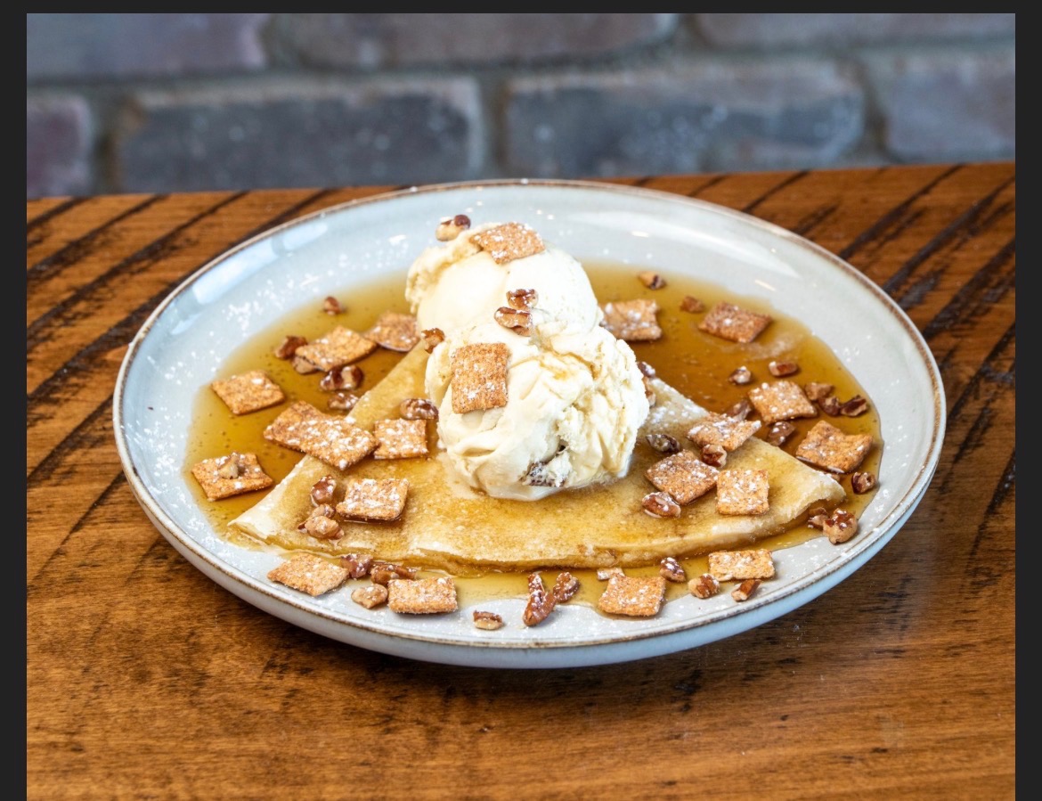 Crepe with vanilla ice cream, cinnamon cereal squares, pecans and syrup